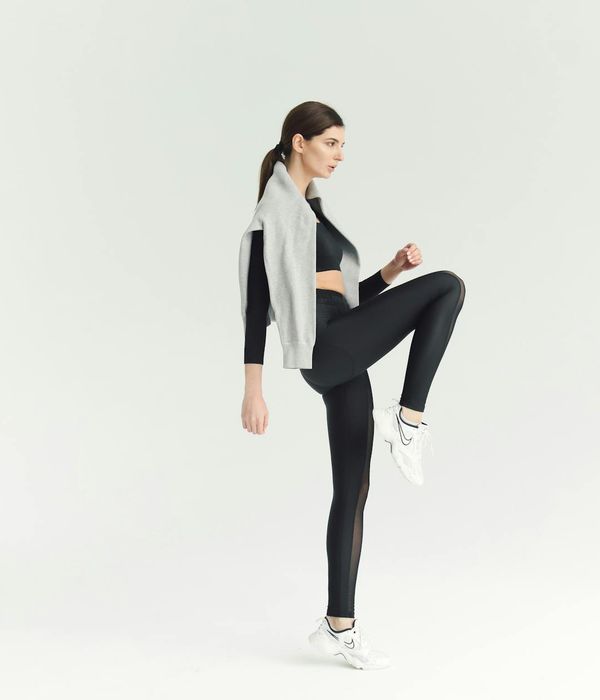 Active woman feeling energetic during a light cardio workout in a modern studio.